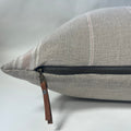 Handcrafted linen pillow cover in soft pink, white, and tan stripes, displayed on a neutral-toned sofa. The 20x20-inch cover adds warmth and texture to modern, coastal, or boho interiors.
