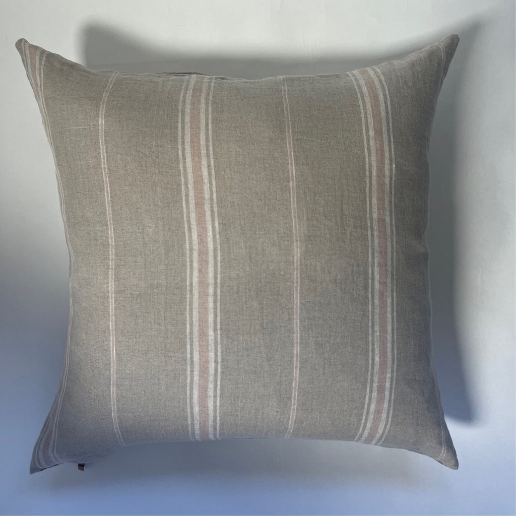 Close-up of the striped linen fabric highlighting the natural texture and soft hues. Pink, white, and tan threads are visible, showcasing artisanal stitching and breathable material.